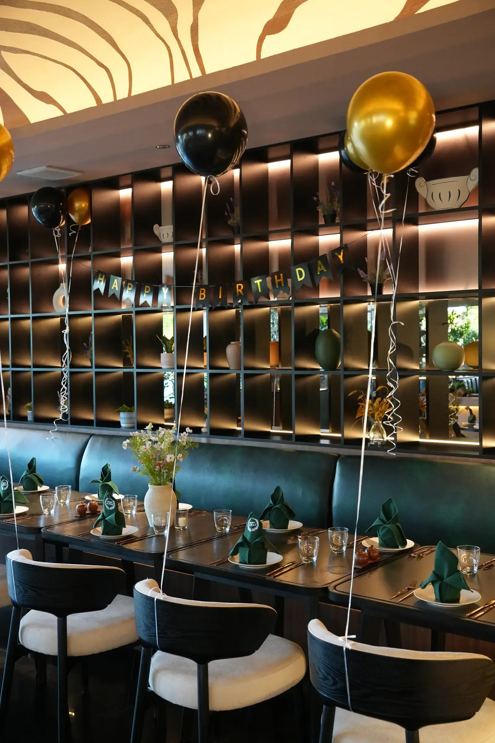 Birthday table set under gold and black balloons at Maison Almaz, Canggu
