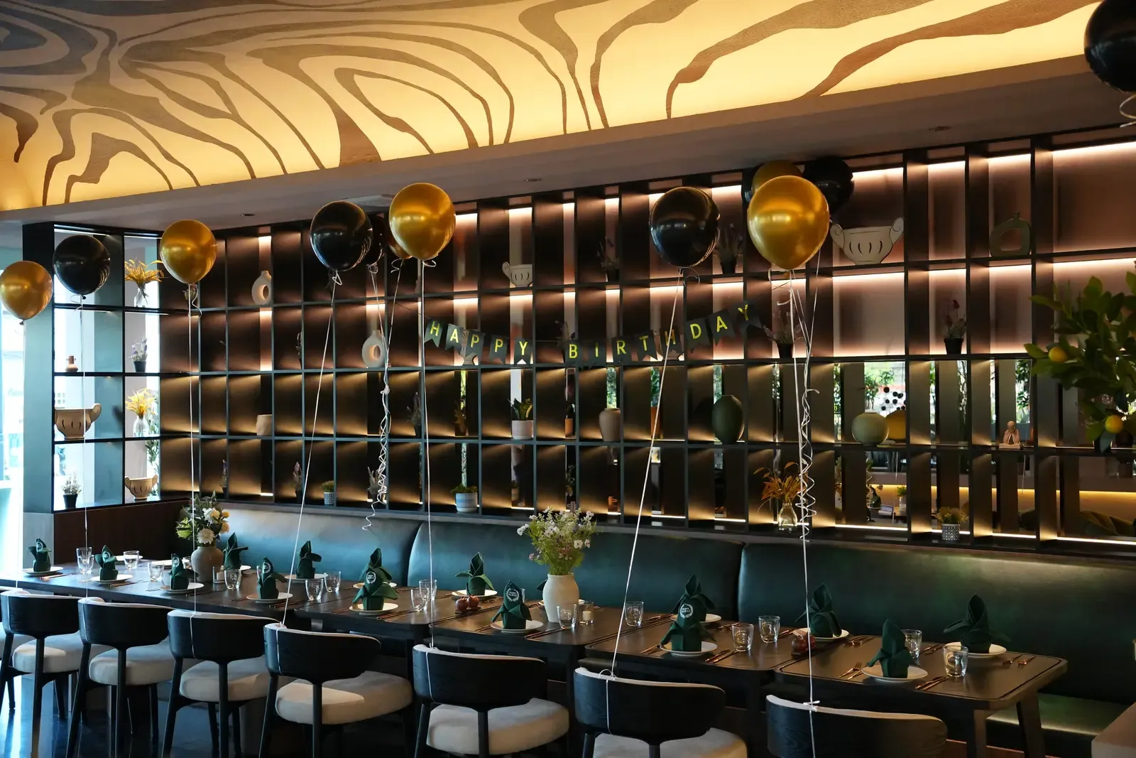 Balloons and a floral centrepiece on a birthday table at Maison Almaz, Canggu