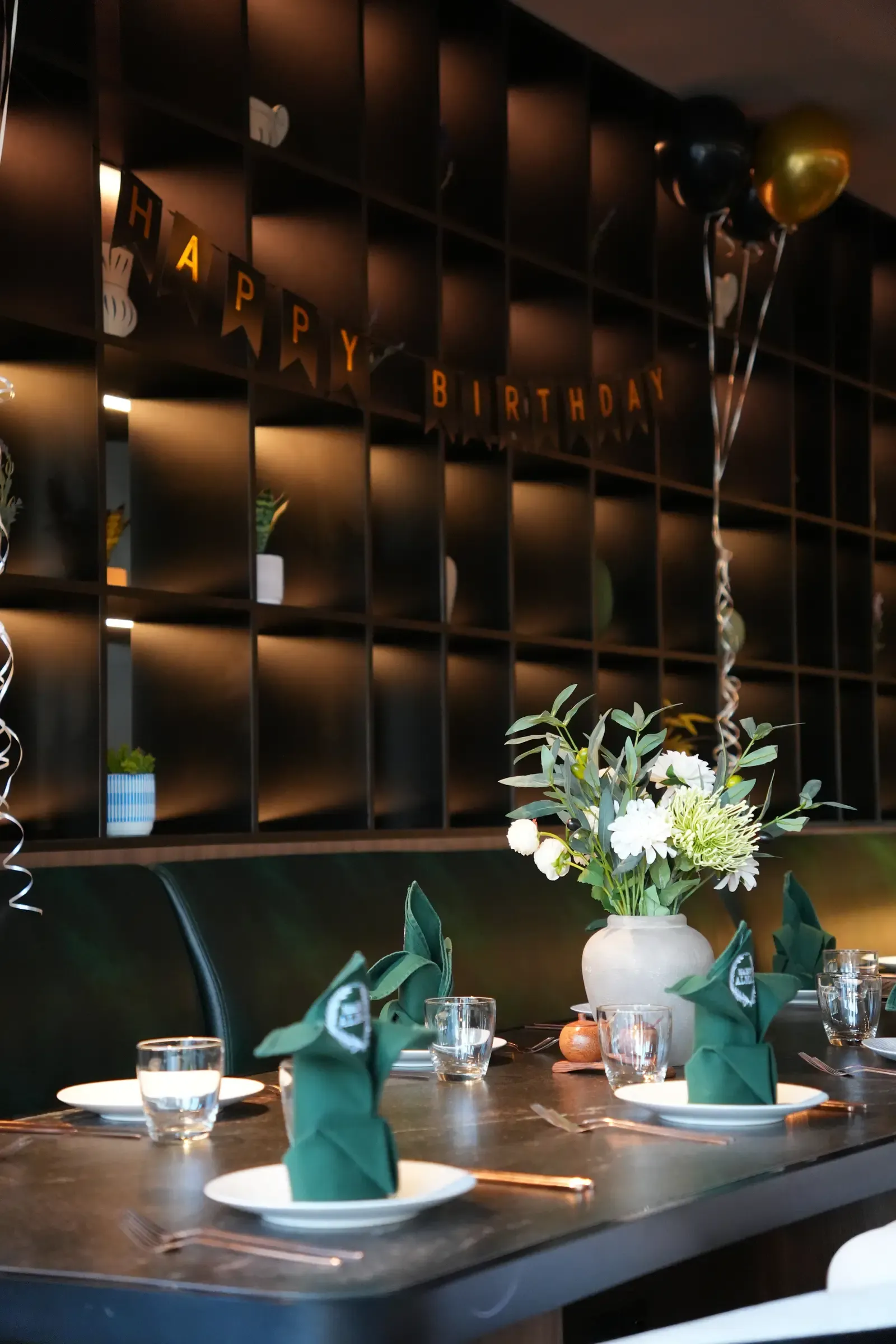 Birthday table decorated with balloons and flowers at Maison Almaz, Canggu