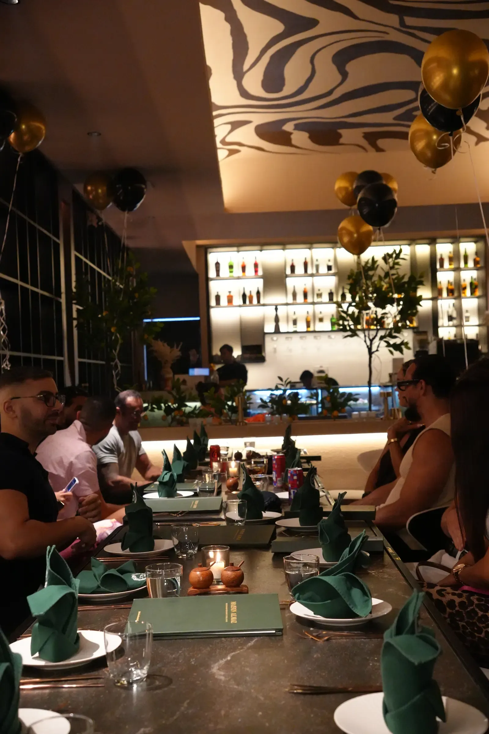 Birthday guests by the bar and dining room at Maison Almaz, Canggu