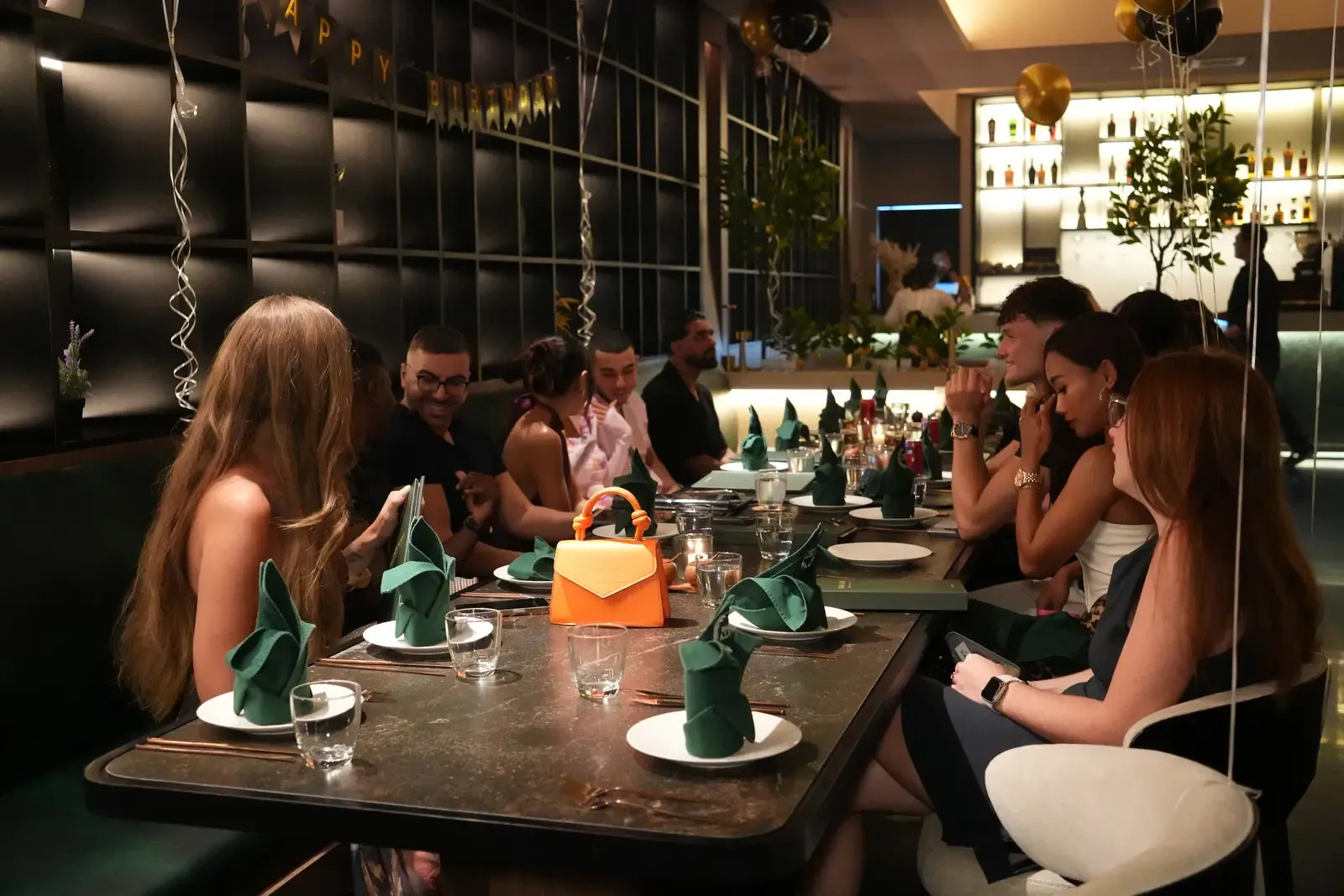 Friends celebrating a birthday around the table at Maison Almaz, Canggu