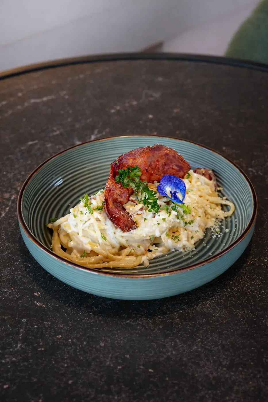 Creamy pasta topped with cured sausage
