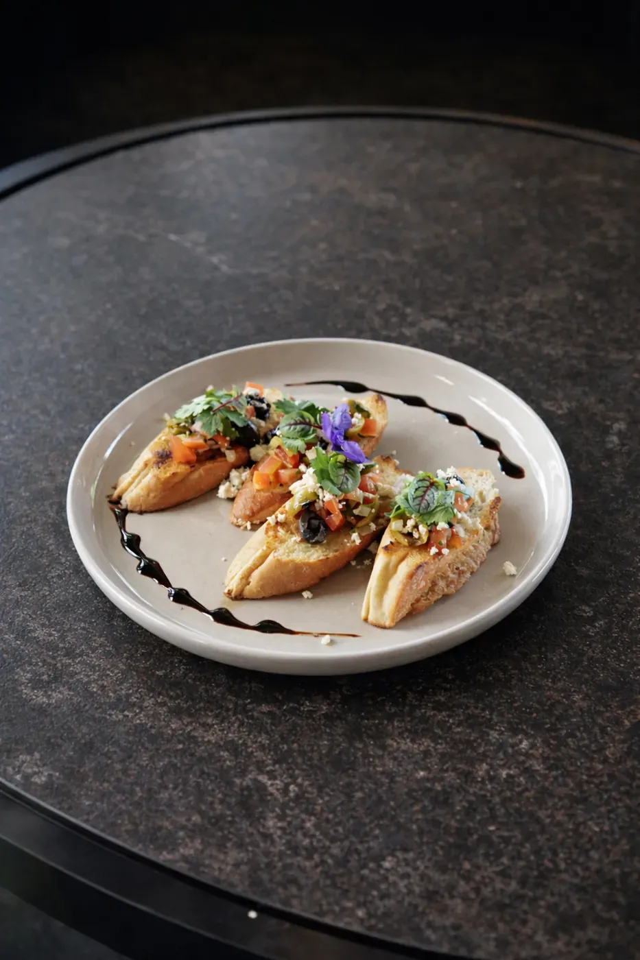Bruschetta toasts finished with balsamic glaze