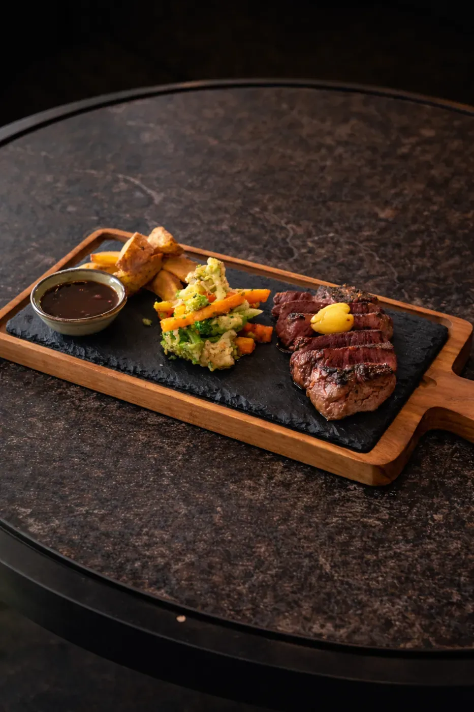 Grilled beef tenderloin steak on a wooden board