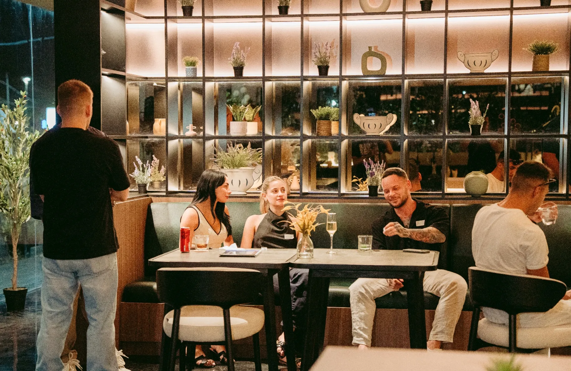 Guests enjoying drinks in elegant booth setting