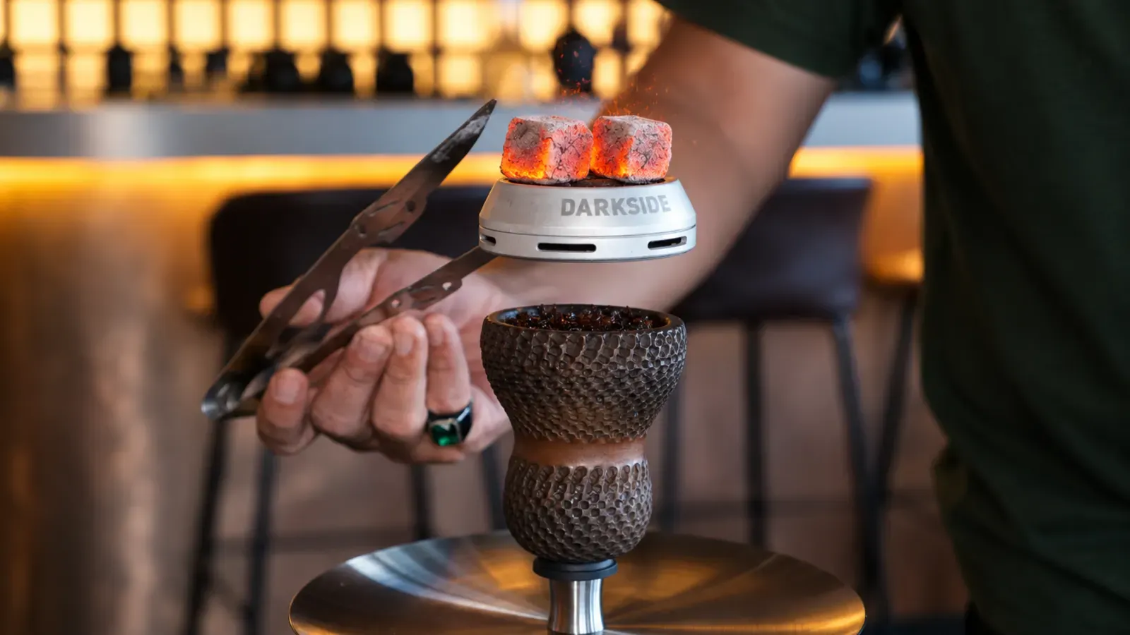 Shisha master placing a glowing coal on a Darkside bowl at Maison Almaz, Canggu