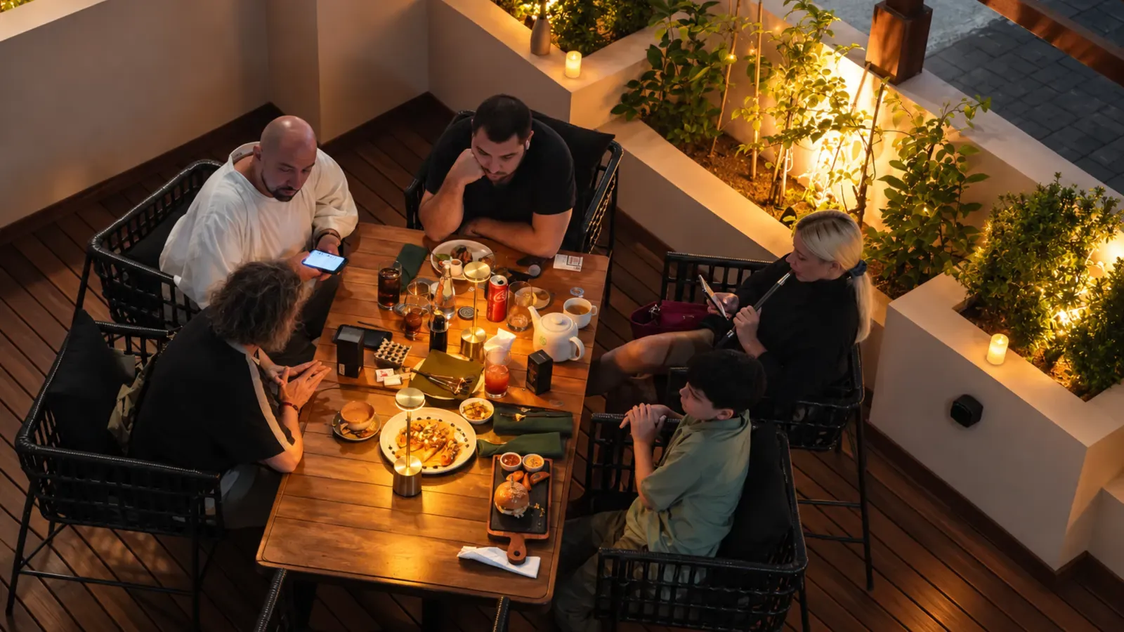 Guests dining on the terrace in the evening at Maison Almaz, Canggu