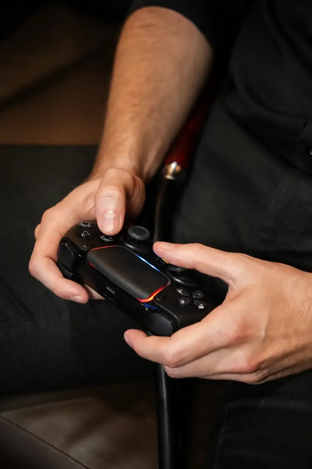 Guest playing on a PlayStation controller in the Private Room at Maison Almaz, Canggu