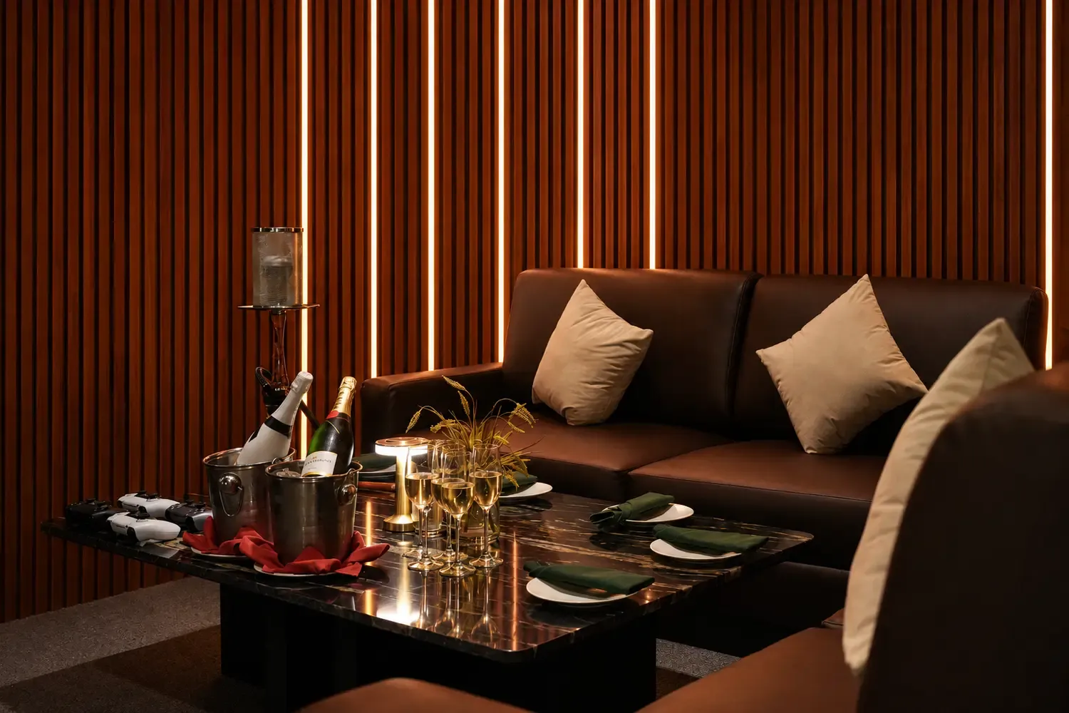 The private Private Room gaming lounge with booth seating and champagne at Maison Almaz, Canggu